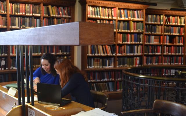 Two students studying in the History Faculty Library