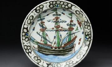 A plate with a painting of a ship