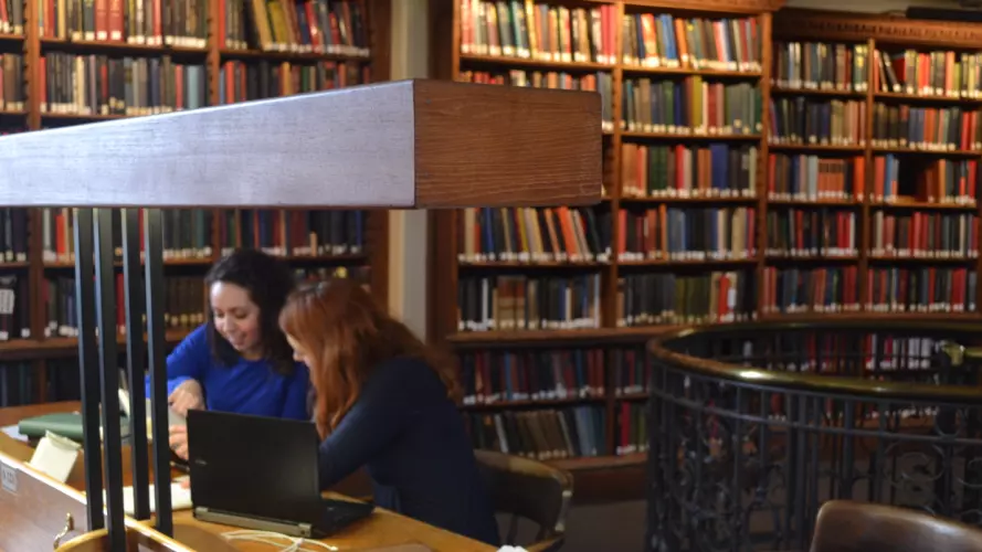 two students studying in the library