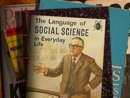 A poster showing a fake book cover with a man giving a lecture