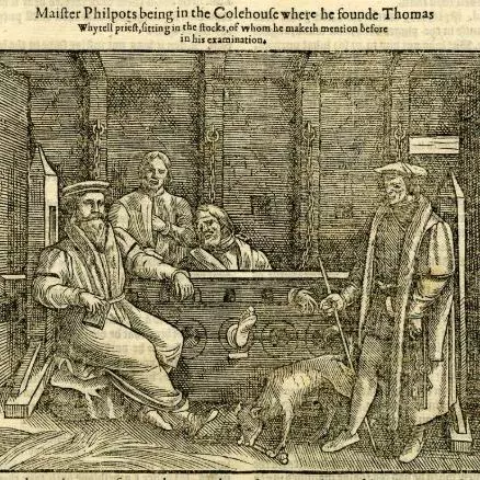 A prison cell, with one man in the stocks, three other men standing or sitting, and a dog chewing on a bone; illustration to page 1418 of a 16th-century edition of John Foxe, 'Acts and Monuments' ('Book of Martyrs').