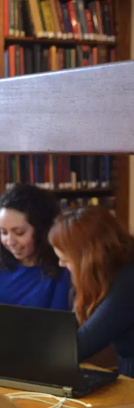 two students studying in the library
