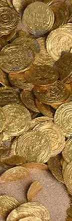 Gold coins in sand
